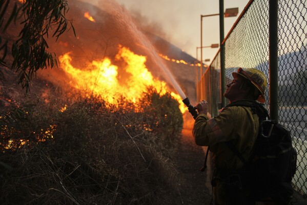 Firefighters look out over the Kenneth Fire, Jan. 9, 2025, in the West Hills section of Los Angeles. (AP Photo/Eric Thayer, File)