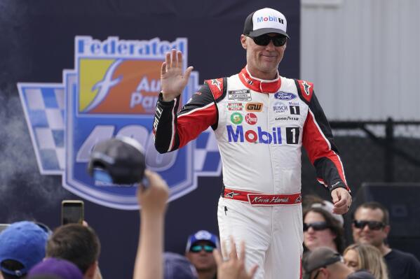 FILE - Kevin Harvick greets fans during driver introductions prior to the start of a NASCAR Cup Series auto race at Richmond Raceway, Sunday, Aug. 14, 2022, in Richmond, Va. Harvick is looking for the exit ramp as he enters his final season as a NASCAR driver, at the same time seven-time champion Jimmie Johnson is sliding back into stock cars. This 75th season of NASCAR begins Sunday, Feb. 19, 2023, with the Daytona 500 and is a year of both celebration and transition. (AP Photo/Steve Helber, File)
