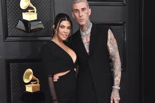 FILE - Kourtney Kardashian, left, and Travis Barker appear at the 64th Annual Grammy Awards in Las Vegas on April 3, 2022.   According to reports, Friday, May 20, Kardashian and Barker hit Portofino for a long wedding weekend.  (Photo by Jordan Strauss/Invision/AP, File)