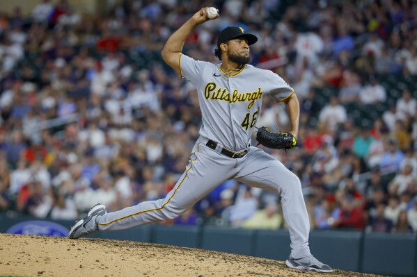 FILE - Pittsburgh Pirates relief pitcher Yohan Ramirez throws to the Minnesota Twins in the seventh inning of a baseball game Aug. 18, 2023, in Minneapolis. Ramirez was acquired by the New York Mets from the Chicago White Sox on Monday, Dec. 18, for $100,000. (AP Photo/Bruce Kluckhohn, File)