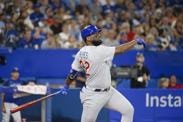 Chicago Cubs' Franmil Reyes (32) watches his home run against the Toronto Blue Jays during the fifth inning of a baseball game Wednesday, Aug. 31, 2022, in Toronto. (Christopher Katsarov/The Canadian Press via AP)