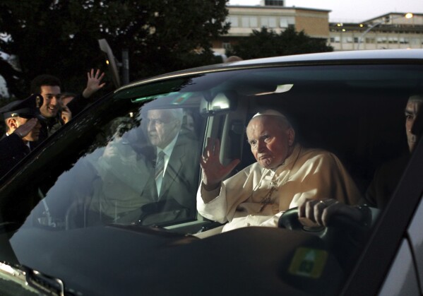 Pope John Paul II leaves Rome's Gemelli Polyclinic Hospital, Sunday, March 13, 2005. (AP Photo/Domenico Stinellis, File)