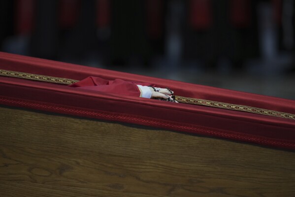 The body of Pope Francis inside St. Peter's Basilica at the Vatican, Wednesday, April 23, 2025, where he will lie in state for three days. (AP Photo/Alessandra Tarantino)