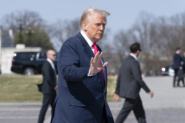 President Donald Trump waves to the media as he leaves after a luncheon with the Speaker of the House Mike Johnson, R-La., and Ireland's Prime Minister Micheal Martin at the U.S. Capitol on Wednesday, March 12, 2025, in Washington. (AP Photo/Jose Luis Magana)