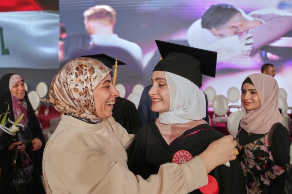 An Iraqi mother celebrates with her daughter during the first graduation for The American University of Iraq - Baghdad students in Baghdad, Iraq, Saturday, May 24, 2025. (AP Photo/Hadi Mizban)