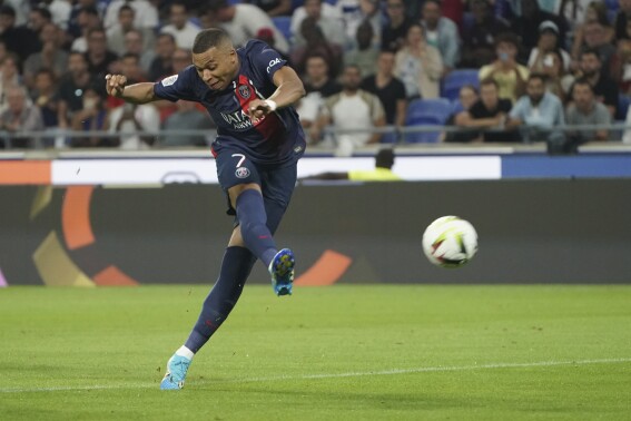 PSG's Kylian Mbappe shoots on target during the French League One soccer match between Lyon and Paris Saint-Germain at the Groupama stadium, outside Lyon, France, Sunday, Sept. 3, 2023. (AP Photo/Laurent Cipriani)