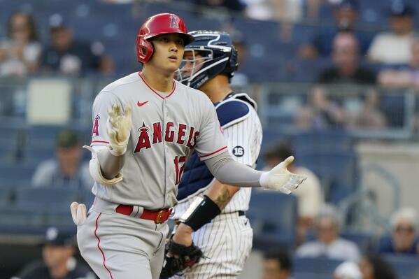 Los Angeles Angels designated hitter Shohei Ohtani claps as he crosses the plate after hitting a solo home run on his first at-bat during the first inning of a baseball game against the New York Yankees, Monday, June 28, 2021, at Yankee Stadium in New York. (AP Photo/Kathy Willens)