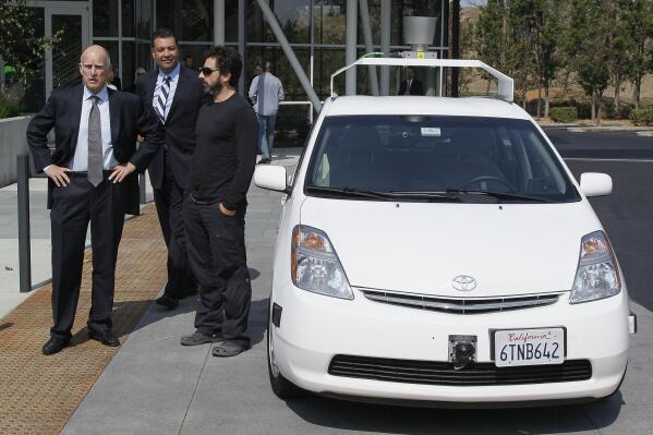 From left, California Gov. Edmund G Brown Jr., state Senator Alex Padilla and Google co-founder Sergey Brin stand by a driverless car they arrived in at Google headquarters in Mountain View, Calif., Tuesday, Sept. 25, 2012.  Brown visited Google to sign legislation for driverless cars. The legislation will open the way for driverless cars in the state. Google, which has been developing autonomous car technology and lobbying for the legislation has a fleet of driverless cars that has logged more than 300,000 miles (482,780 kilometers) of self-driving on California roads. (AP Photo/Eric Risberg)