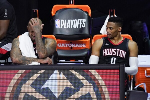 Houston Rockets' P.J. Tucker, left, and Russell Westbrook sit on the bench in the closing minutes of a loss to the Los Angeles Lakers during the second half of an NBA conference semifinal playoff basketball game Saturday, Sept. 12, 2020, in Lake Buena Vista, Fla. (AP Photo/Mark J. Terrill)