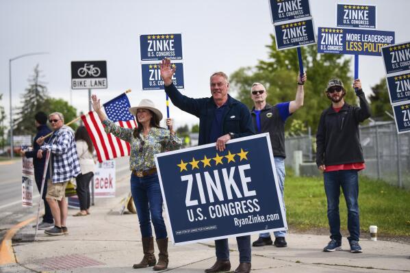 Montana U.S. House candidate and former Secretary of Interior Ryan Zinke waves to passing motorists outside the Flathead County Fairgrounds in Kalispell, Mont., on Tuesday, June 7, 2022. (Casey Kreider/The Daily Inter Lake via AP)