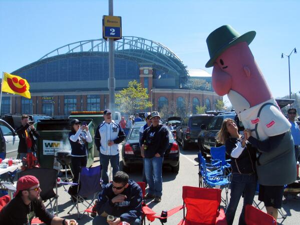 Milwaukee Brewers fans interact with Brat, one of the five popular Racing  Sausages that are fan favorites at Miller Park, Friday, April 6, 2012,  before the season opener baseball game against the
