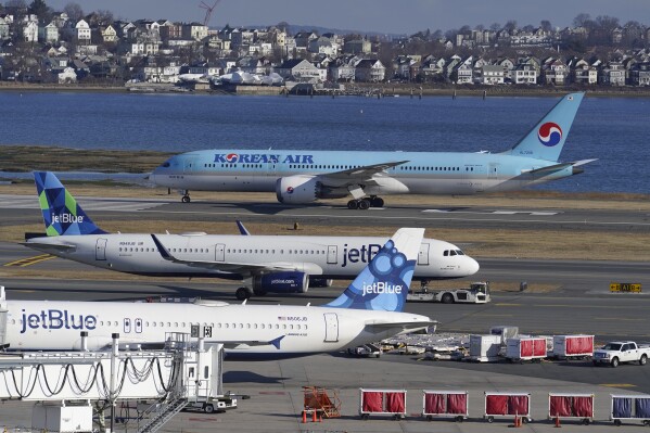 FILE - Passenger jets are seen on the tarmac at Logan International Airport, Jan. 11, 2023, in Boston. The Federal Aviation Administration is considering requiring that all planes be equipped with technology designed to prevent close calls around airports, Friday, Sept. 8. (AP Photo/Steven Senne, File)