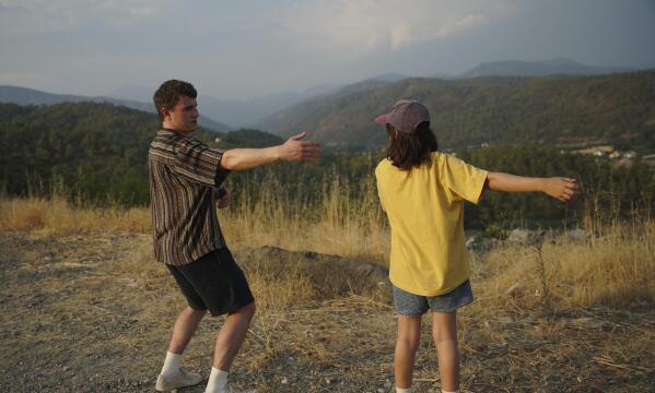 This image released by A24 shows Paul Mescal, left, and Frankie Corio in a scene from "Aftersun." (A24 via AP)
