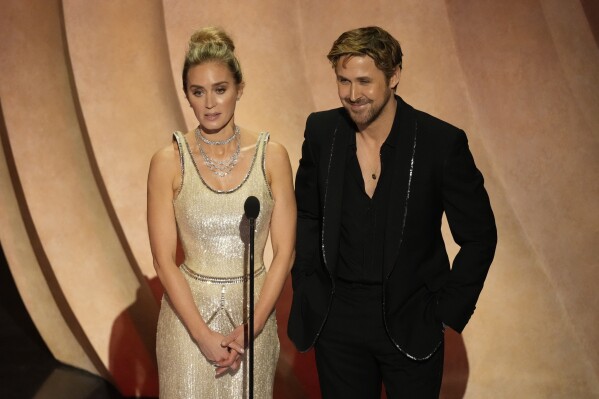 Emily Blunt, left, and Ryan Gosling speak during the Oscars on Sunday, March 10, 2024, at the Dolby Theatre in Los Angeles. (AP Photo/Chris Pizzello)