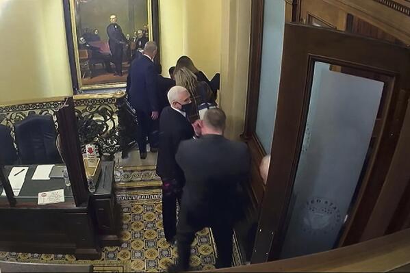 In this image from video, a security video shows Vice President Mike Pence being evacuated from near the Senate chamber as rioters breach the Capitol, on Jan. 6, 2021, at the Capitol in Washington. Pence won’t be testifying at Thursday’s Jan. 6 committee hearing. But he will be in the spotlight as the group turns its focus to former President Donald Trump’s desperate attempts to persuade Pence to overturn the results of the 2020 presidential election. (Senate Television via AP)