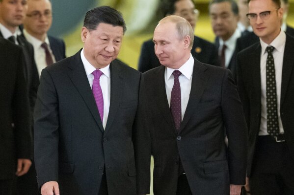 FILE - In this June 5, 2019, file photo, Russian President Vladimir Putin, center right, and Chinese President Xi Jinping, center left, enter a hall for the talks in the Kremlin in Moscow, Russia. Putin and Xi have established themselves as the world’s most powerful authoritarian leaders in decades. Now it looks like they want to hang on to those roles indefinitely. Putin's sudden announcement of constitutional changes that could allow him to extend control way beyond the end of his term in 2024 echoes Xi’s move in 2018 to eliminate constitutional term limits on the head of state. (AP Photo/Alexander Zemlianichenko, Pool, File)