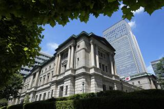 A Japanese flag flutters at the Bank of Japan headquarters in Tokyo on July 29, 2022. Japan’s economy grew at an annual rate of 2.2% for the April-June quarter from the previous quarter, the government said Monday, Aug. 15, as consumer spending rebounded with COVID-19 restrictions getting gradually lifted. (AP Photo/Shuji Kajiyama)