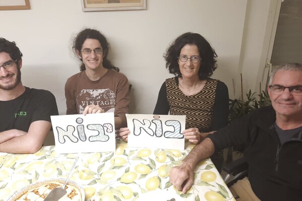 This undated photo released Wednesday Oct. 11, 2023 by Nadav Kipnis, shows him, at left, flanked by his family from left, his brother Yotam Kipnis, his mother Lilach Lea Havron 60 and his father Eviatar Moshe Kipnis 65. Eviatar Moshe Kipnis and Lilach Lea Havron are among the estimated 150 people believed held by Hamas in Gaza following the militant group's stunning incursion in Israel on Saturday. The couple and their health care aide were last heard from Saturday morning, sheltering in their safe room, after militants had begun storming Be'eri, where at least 100 people were later found dead. (Kipnis Family via AP)