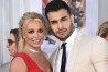 FILE - Britney Spears and Sam Asghari appear at the Los Angeles premiere of "Once Upon a Time in Hollywood" on July 22, 2019. Spears has reached a divorce settlement with her soon-to-be-ex-husband Asghari. (Photo by Jordan Strauss/Invision/AP, File)
