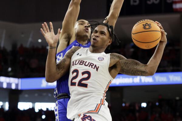 Auburn guard Allen Flanigan (22) is fouled by Kentucky forward Jacob Toppin (0) as he goes up for a lay up during the second half of an NCAA college basketball game Saturday, Jan. 22, 2022, in Auburn, Ala. (AP Photo/Butch Dill)