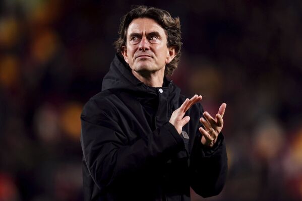 Brentford's head coach Thomas Frank applauds after the English Premier League soccer match between Brentford and Brighton and Hove Albion at the Gtech Community Stadium, London, Wednesday, April 3, 2024. (John Walton/PA via AP)