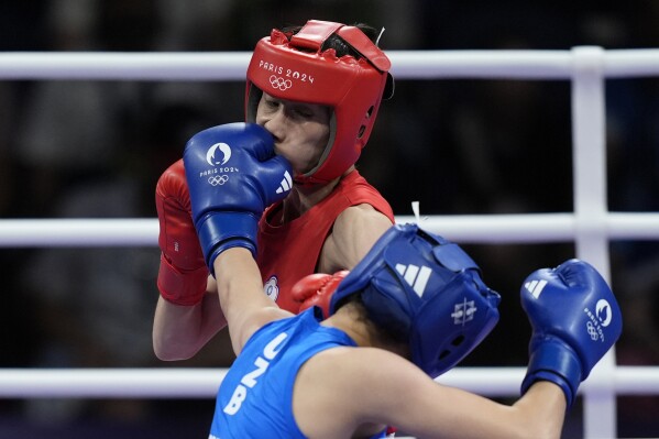 Uzbekistan's Sitora Turdibekova hits Taiwan's Lin Yu-ting in their women's 57 kg preliminary boxing match at the 2024 Summer Olympics, Friday, Aug. 2, 2024, in Paris, France. (AP Photo/John Locher)