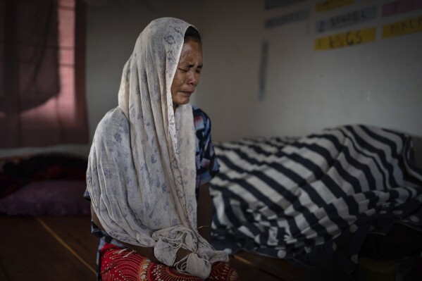 Kim Neineng, 43, a tribal Kuki, cries as she narrates the killing of her husband, at a relief camp in Churachandpur, in the northeastern Indian state of Manipur, Tuesday, June 20, 2023. Neineng escaped with her four children to a nearby relief camp when a Meitei mob descended on their village. Her husband was killed by the mob — beaten with iron bars, his legs chopped off and then picked and tossed in the raging fire that had already engulfed his home. The deadly conflict between the two ethnic communities has killed at least 120 people. (AP Photo/Altaf Qadri)