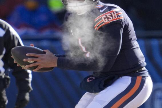 Chicago Bears quarterback Justin Fields (1) dropS back to throw against the Buffalo Bills in the first half of an NFL football game in Chicago, Saturday, Dec. 24, 2022. (AP Photo/Nam Y. Huh)