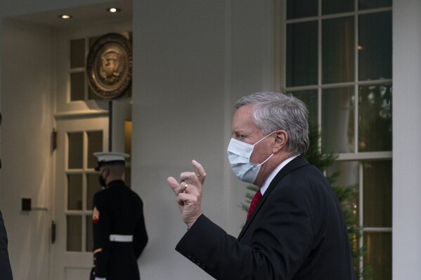 White House chief of staff Mark Meadows talks with reporters as he walks back to the West Wing of the White House, Wednesday, Oct. 7, 2020, in Washington. (AP Photo/Alex Brandon)