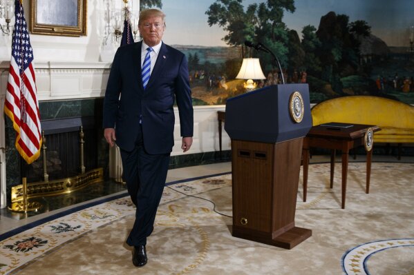 
              President Donald Trump walks off after delivering a statement on the Iran nuclear deal from the Diplomatic Reception Room of the White House, Tuesday, May 8, 2018, in Washington. Trump announced the U.S. will pull out of the landmark nuclear accord with Iran, dealing a profound blow to U.S. allies and potentially deepening the president's isolation on the world stage.  (AP Photo/Evan Vucci)
            