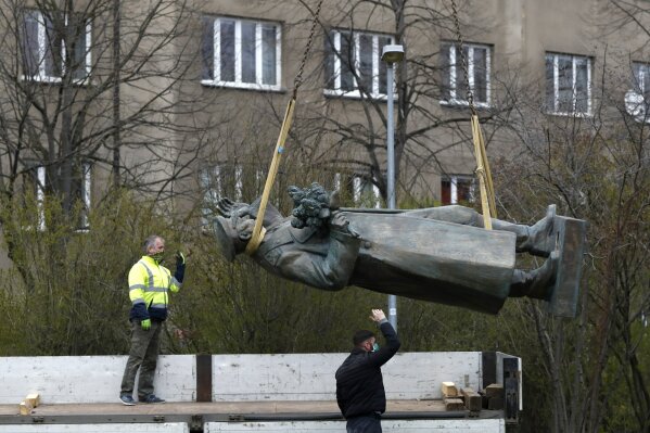The statue of a Soviet World War II commander Marshall Ivan Stepanovic Konev is loaded onto a truck after its been removed from its site in Prague, Czech Republic, Friday, April 3, 2020. Marshall Konev led the Red Army forces that liberated Prague and large parts of Czechoslovakia from the Nazi occupation in 1945. His monument, unveiled in the Prague 6 district in 1980 when the country was occupied by Soviet troops, has been a source of controversy. (AP Photo/Petr David Josek)