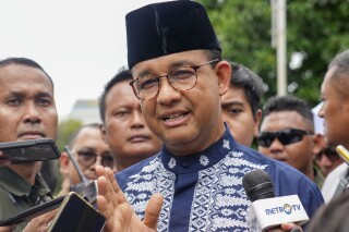 FILE - Presidential candidate Anies Baswedan talks to media after Friday prayer at a mosque in Jakarta, Indonesia, Friday, Feb. 16, 2024. Baswedan, a runner-up in Indonesia’s presidential election filed a complaint with the Constitutional Court on Thursday, March 21, alleging widespread irregularities and fraud at the polls.(AP Photo/Tatan Syuflana, File)
