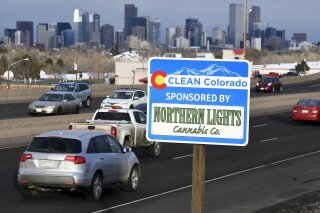 In this Feb. 6, 2020, photo, a Clean Colorado highway sign sponsored by the Northern Lights Cannabis Co. is displayed on eastbound 6th Avenue west of Sheridan Blvd. in Denver. (Andy Cross/The Denver Post via AP)