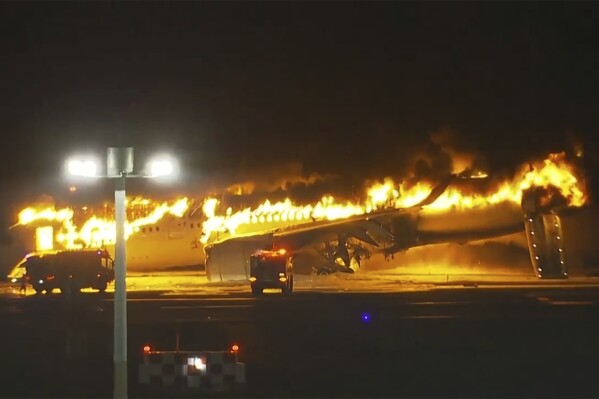 In this image made from video, a Japan Airlines plane is on fire on the runway of Haneda airport on Tuesday, Jan. 2, 2024 in Tokyo, Japan. (NTV via AP)