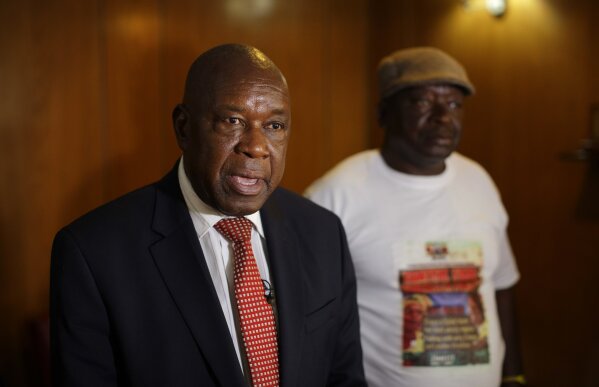 
              Chris Mutsvangwa, head of Zimbabwe's association of war veterans, speaks to The Associated Press calling for President Robert Mugabe to step down immediately, in downtown Harare, Zimbabwe Tuesday, Nov. 21, 2017. The ruling ZANU-PF party was poised to begin impeachment proceedings Tuesday against Mugabe after its Central Committee voted to oust the president as party leader. (AP Photo/Ben Curtis)
            