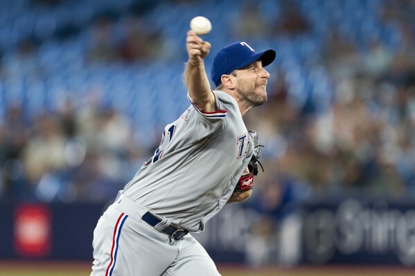 Texas Rangers starting pitcher Max Scherzer works against the Toronto Blue Jays during the fourth inning of a baseball game Tuesday, Sept. 12, 2023, in Toronto. (Spencer Colby/The Canadian Press via AP)