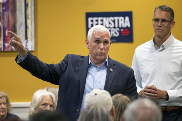 Former Vice President Mike Pence answers questions from the audience during the Woodbury County GOP and Republican Women meet and greet at Pizza Ranch with Rep. Randy Feenstra, right, in Sioux City, Iowa, Wednesday, July 5, 2023. (Jesse Brothers/Sioux City Journal via AP)