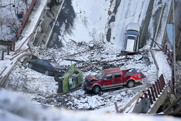 FILE - Four of five cars and a Pittsburgh Transit Authority bus lies in the rubble on Monday, Jan. 31, 2022, of the Fern Hollow Bridge in Pittsburgh that collapsed Friday, Jan. 28, 2022. Federal regulators are about to determine what they believe caused a bridge to collapse in Pittsburgh more than two years ago, sending vehicles plummeting into a ravine and injuring several people. AP Photo/Gene J. Puskar, File)