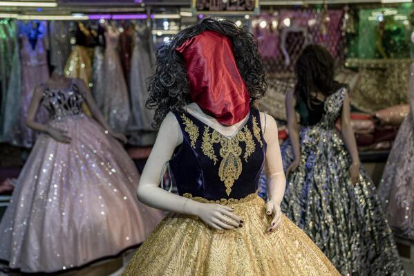 A mannequin's head is covered in a woman dress shop in Kabul, Afghanistan, Monday, Dec. 26, 2022. Under the Taliban, the mannequins in women's dress shops across the Afghan capital Kabul are a haunting sight, their heads cloaked in cloth sacks or wrapped in black plastic bags. The hooded mannequins are one symbol of the Taliban's puritanical rule over Afghanistan (AP Photo/Ebrahim Noroozi)