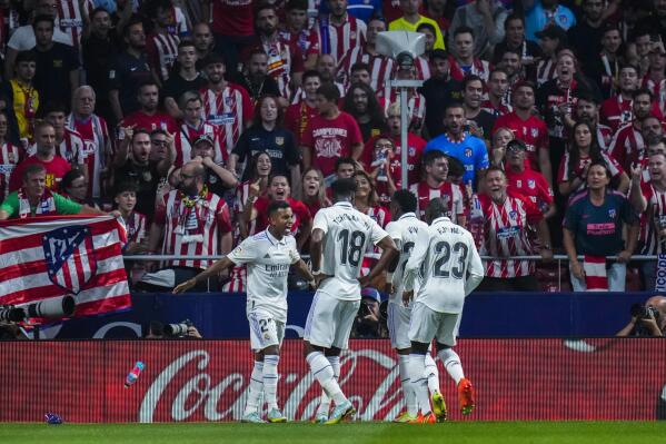 Real Madrid's Rodrygo, left, celebrates with teammates after scoring the opening goal during the Spanish La Liga soccer match between Atletico Madrid and Real Madrid at the Wanda Metropolitano stadium in Madrid, Spain, Sunday, Sept. 18, 2022. (AP Photo/Manu Fernandez)