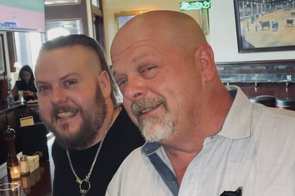 This undated photo provided by Laura Herlovich shows from left, Adam and Rick Harrison. Adam, one of three sons of reality TV show “Pawn Stars” celebrity Richard “Rick” Harrison, has died in Las Vegas, a family representative said Saturday, Jan. 20, 2024. He was 39. (Laura Herlovich via AP)