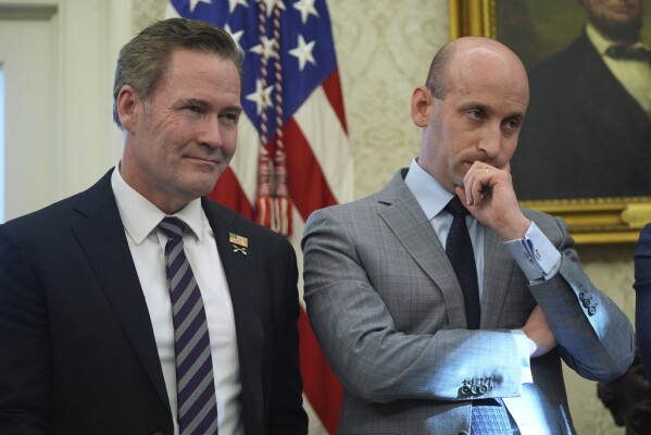 White House national security adviser Mike Waltz and White House adviser Stephen Miller listen as President Donald Trump speaks to reporters as he signs executive orders in the Oval Office of the White House, Tuesday, Feb. 4, 2025, in Washington. (AP Photo/Evan Vucci)