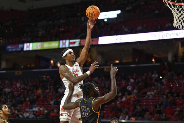 Maryland forward Julian Reese shoots the ball over Coppin State forward Justin Winston (35) during the first half of an NCAA basketball game, Friday, Nov. 25, 2022, in College Park, Md. (AP Photo/Terrance Williams)