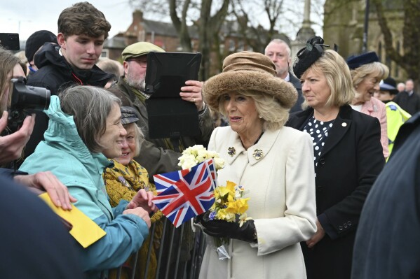 Britain's Queen Camilla meets well-wishers after attending the Royal Maundy Service, in Worcester, England, Thursday, March 28, 2024. Maundy Thursday is the Christian holy day falling on the Thursday before Easter. The monarch commemorates Maundy by offering 'alms' to senior citizens. Each recipient receives two purses, one red and one white. (Justin Tallis, Pool Photo via AP)