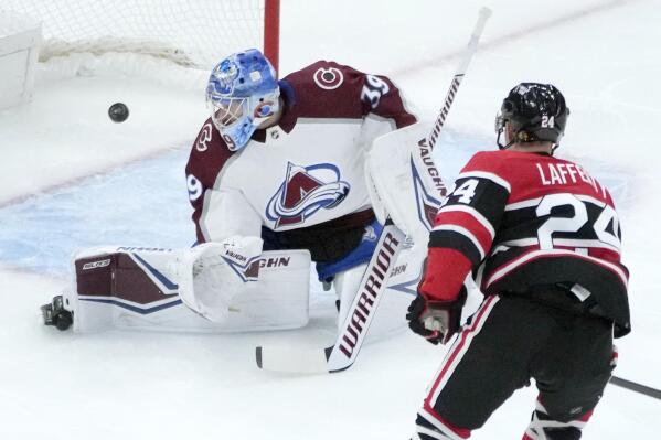 Chicago Blackhawks' Sam Lafferty (24) watches his shot score past Colorado Avalanche goaltender Pavel Francouz during the first period of an NHL hockey game Thursday, Jan. 12, 2023, in Chicago. (AP Photo/Charles Rex Arbogast)