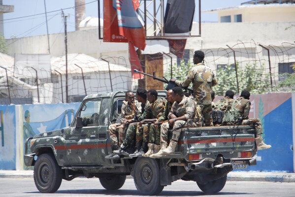 Somalia security officers patrol near the SYL hotel building which was attacked on Thursday by al-Shabab Islamic extremist rebels in Mogadishu, Somalia, Friday March 15, 2024. The Somali extremist group al-Shabab said its fighters have attacked a hotel in the capital Mogadishu, where a loud explosion and gunfire were heard Thursday night. (AP Photo/Farah Abdi Warsameh)