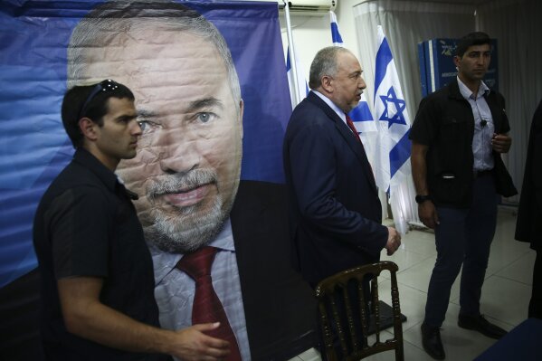 Former Israeli Defense Minister and Yisrael Beiteinu party leader Avigdor Lieberman, center, leaves a press conference in Tel Aviv, Israel, Thursday, May 30, 2019. Israel embarked on an unprecedented second, snap election this year after Prime Minister Benjamin Netanyahu failed to form a governing coalition and instead dissolved parliament. Netanyahu was unable to build a parliamentary majority because his traditional ally, Lieberman, refused to bring his faction into the coalition. (AP Photo/Oded Balilty)