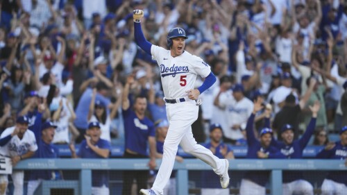 Los Angeles Dodgers' Freddie Freeman (5) celebrates after Will Smith (16) hit a home run during the eighth inning of a baseball game against the Houston Astros in Los Angeles, Sunday, June 25, 2023. They both scored. (AP Photo/Ashley Landis)