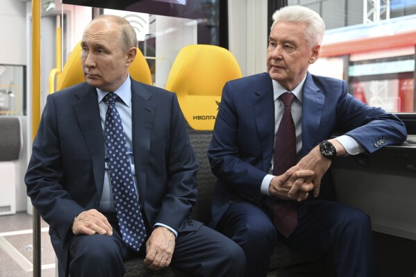 FILE - Russian President Vladimir Putin, left, and Moscow Mayor Sergei Sobyanin sit in a railway carriage exploring the Manezh Metro Station exhibition prior to the ceremony to launch passenger traffic on the Line D3 of Moscow Central Diameters via videoconference, at the Manezh Central Exhibition Hall in Moscow, Russia, Thursday, Aug. 17, 2023. Sobyanin could be an establishment-supported candidate for Russian president if Vladimir Putin does not run for reelection or becomes incapacitated before the vote in March 2024. (Kristina Kormilitsyna, Sputnik, Kremlin Pool Photo via AP, File)