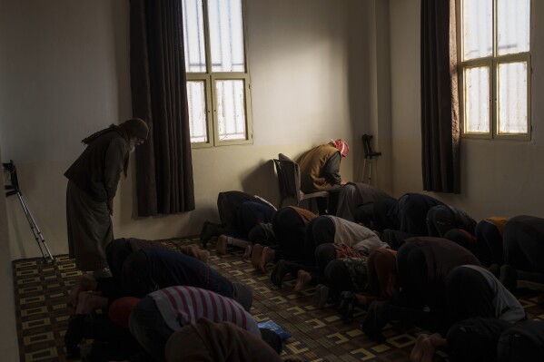 men attend prayers in the al-hol detention camp in northeastern syria's hasakeh province, where tens of thousands of mostly women and children linked to the islamic state group have been living for years, thursday, jan. 30, 2025. (ap photo/bernat armangue)